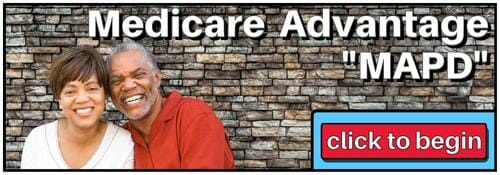 Older couple smiling in front of red brick wall. White letters spelling out Medicare Advantage "MAPD"